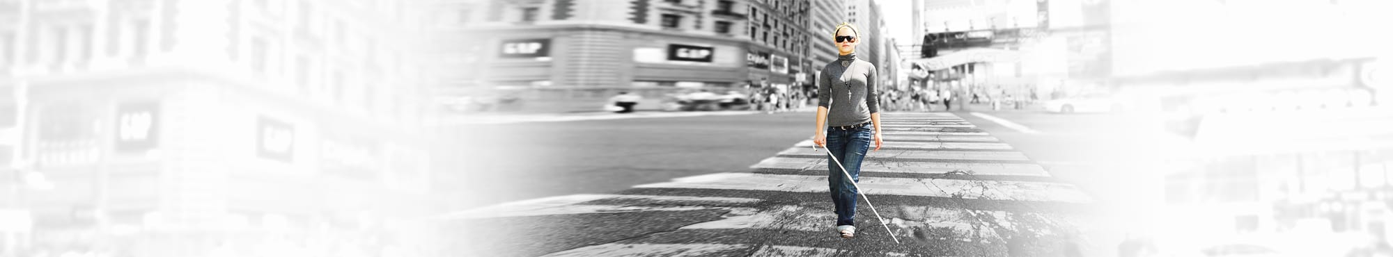 Girl with white cane crossing street